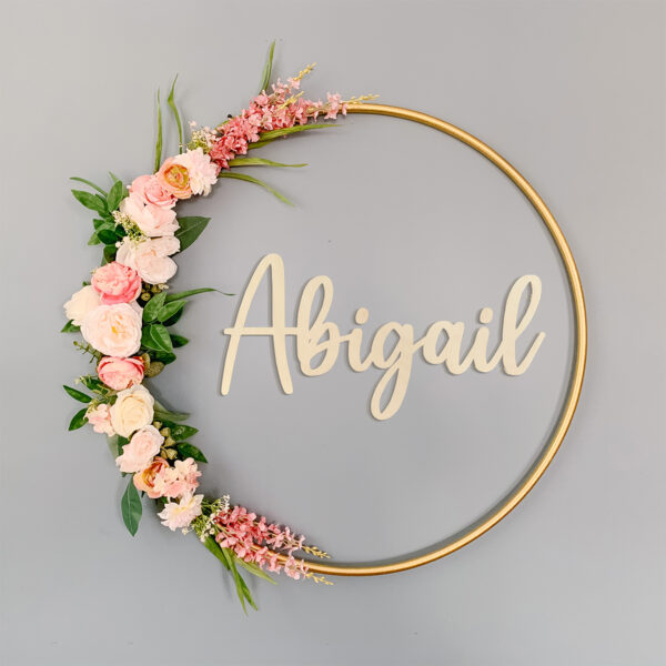 Abigail cut out in wood with a floral hoop